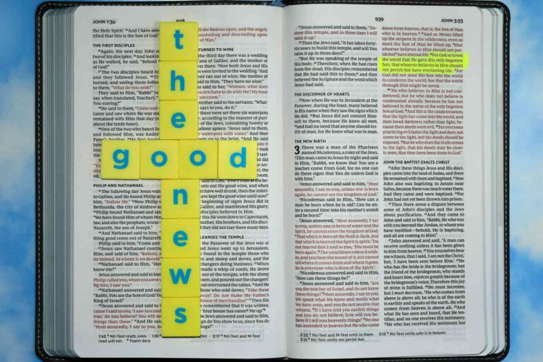 Word blocks on top of a bible spelling "the good news" with John 3:16 highlighted